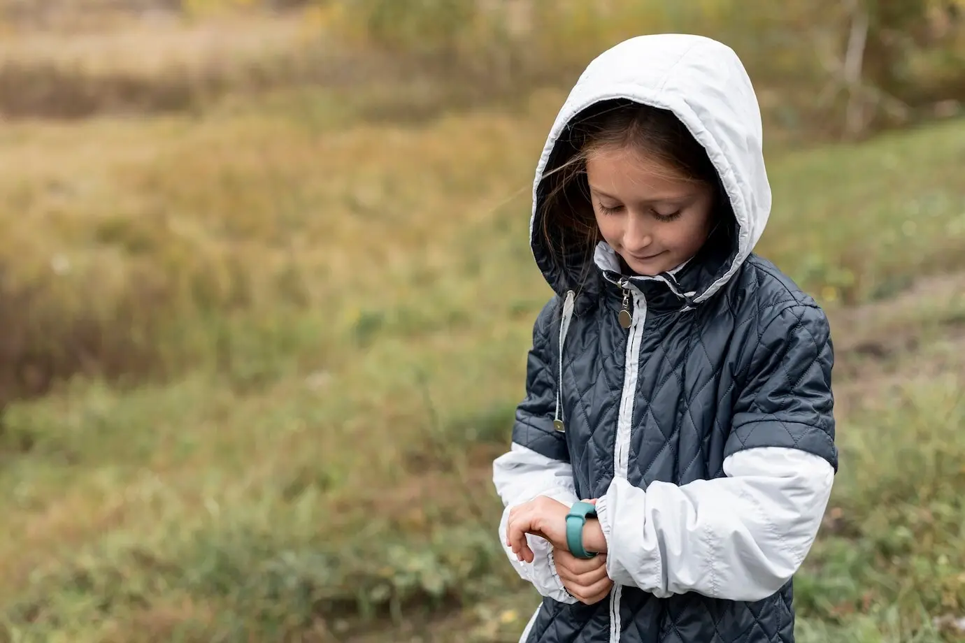 Adorable little girl adjusting her watch
